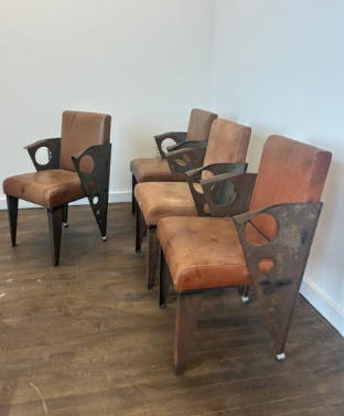 Four custom leather and steel chairs. Made in the 1970s in Italy. Unsigned. Available individually. 

Note: signs of age and use including rust and patina to metal frames and discoloration to original leather upholstery.